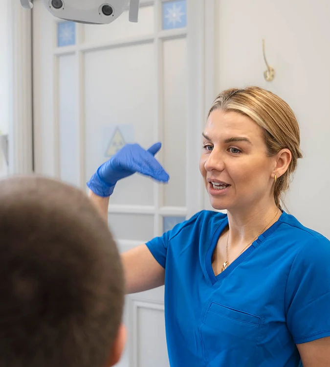 Dentist explaining treatment to a patient with a gesture
