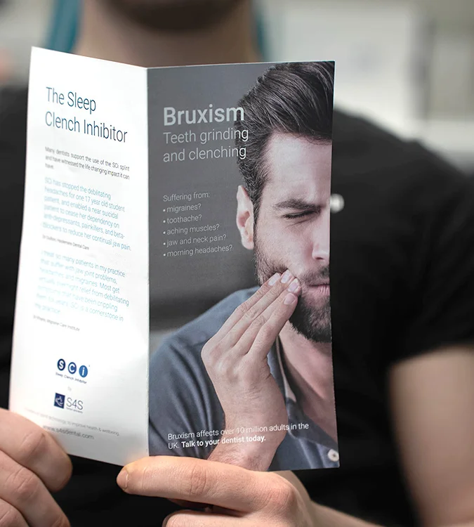 Patient reading a leaflet about bruxism and teeth grinding