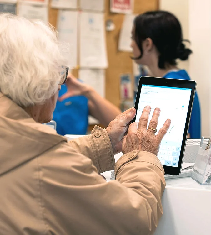 Patient using a tablet at the Quay Dental reception desk