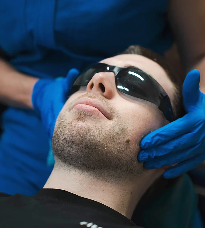 Clinician gently assessing a patient’s jaw